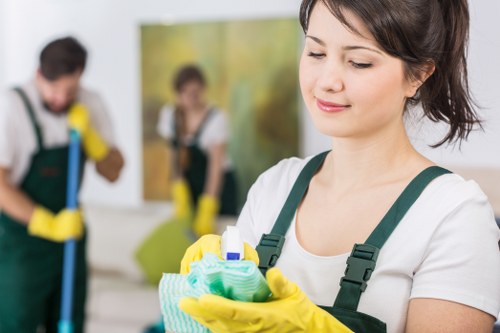 Technician applying carpet cleaning solution with careful safety measures